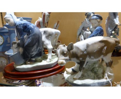 A pair of Royal Copenhagen porcelain figures   comprising Boy With Calf, No.772 and Girl With Calf, No.779, the larger 6«in. 