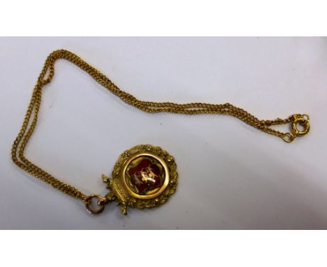 A 9ct gold and enamel medal pendant with Guernsey crest   inscribed verso with dedication dated 1920, on gold plated chain. 