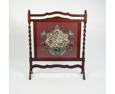WALNUT STAINED CARVED WOOD FIRESCREEN, with barley twist uprights, wavy top handle rail and wool work central glazed panel, w
