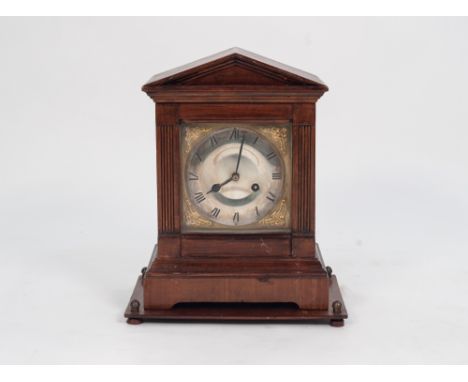 EARLY TWENTIETH CENTURY WALNUT AND STAINED FRUITWOOD MANTLE CLOCK, the 6" silvered Roman dial with pierced gilt spandrels, po