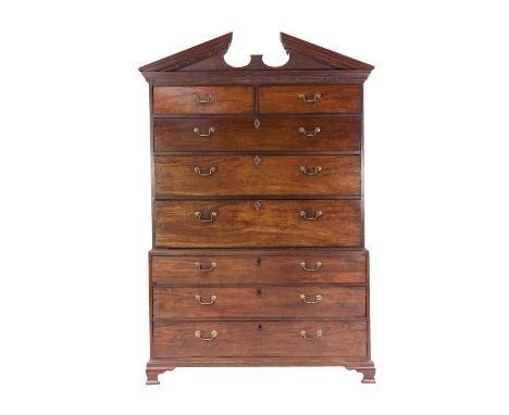 EARLY NINETEENTH CENTURY FIGURED MAHOGANY SECRETAIRE CHEST ON CHEST, the broken architectural pediment with dentil moulded bo