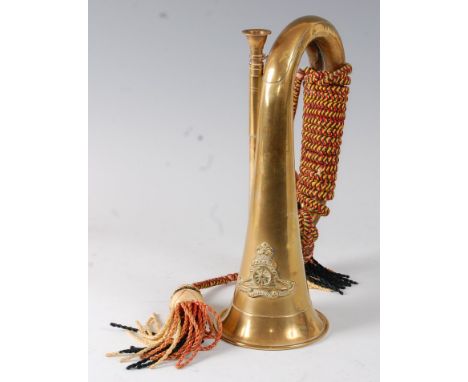 A brass bugle bearing the crest of the Royal Artillery, 27cm.Probably mid to late 20th century.Some light dents to body.Light