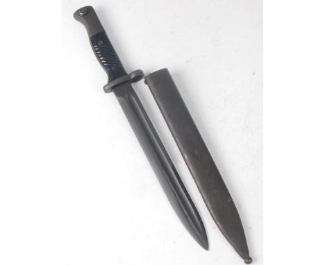 An Israeli K98 Mauser bayonet, having a 24.5cm fullered blade with various markings to the ricasso, housed in a steel scabbar