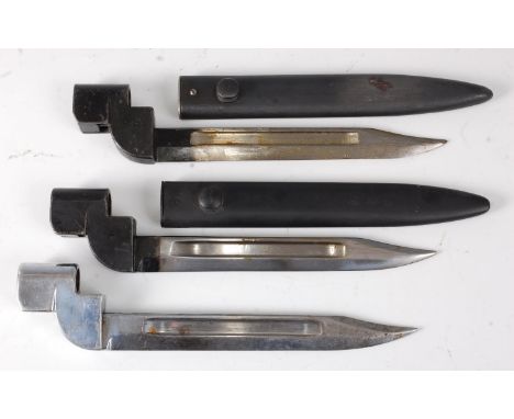 A British No. 9 Mk I bayonet, having a 20cm bowie shaped blade, housed in a steel scabbard, 27cm, together with two other No.
