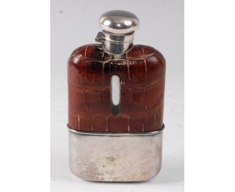 A Victorian hip flask, having a leather clad glass body with silver plated mounts and removeable cup, h.16cm.