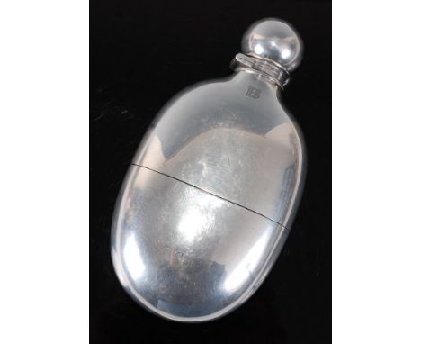 A fine quality Victorian silver hip flask of oval form, the bayonet cap revealing a gilt interior, having a removable cup wit