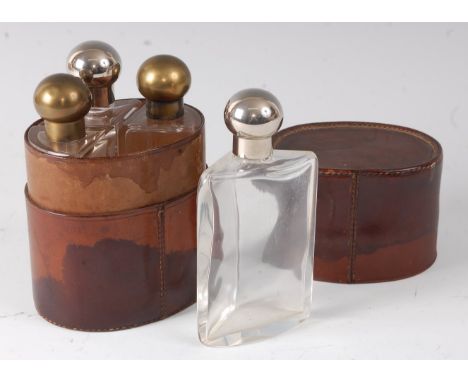 An early 20th century four bottle hunting flask set, each bottle with triangular body and chrome or brass caps, housed in a f