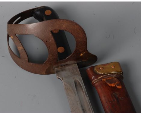 An early 20th century Dutch Naval Klewang, having a 63cm curved fullered blade with steel three bar hilt and two piece bakeli