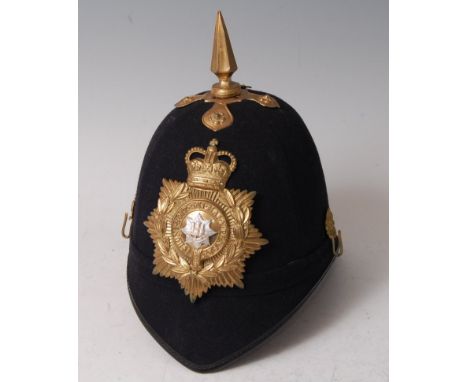 A 20th century Royal Anglian blue cloth covered helmet, having a brass spike above a pressed brass helmet plate with rosette 