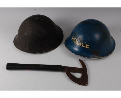 A WW II British steel Mk III turtle helmet, together with a post WW II Mk III Police helmet and a fireman's axe. (3)Provenanc