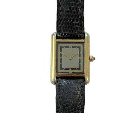 circa 1988, the signed rectangular black and slate grey dial, 15mm diameter, with gold coloured quatre Roman numerals and swo