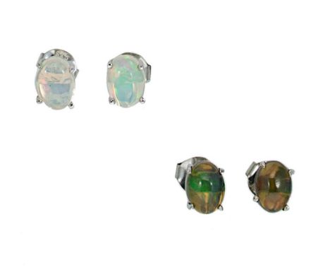 first, a pair of black opal ear studs, each with a single oval shaped cabochon opal, approximately 8 x 6mm, mixed play of col