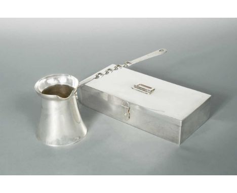 the sandwich box, circa 1910, of rectangular form and plain, polished finish, the piano hinged cover with a centrally placed 