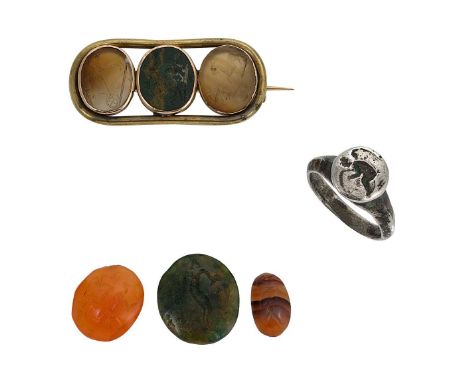 the brooch set with three oval shaped hardstone intaglios, approximately 12 x 10mm, plain narrow yellow metal border, length 