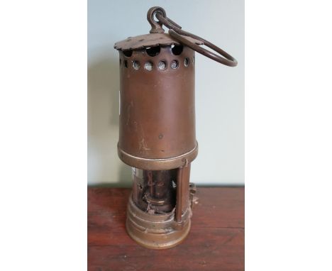 Vintage brass miners lamp with rear shade and locking plate 