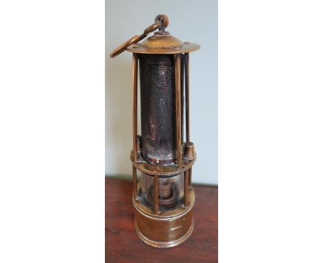 Vintage brass miners lamp converted to electric with mesh top and swinging loop marked F.M
