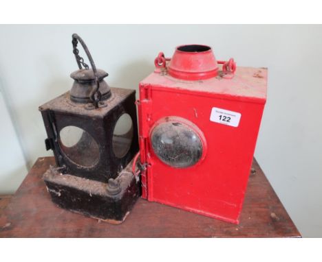 Railway lamp interior and a red painted lamp with bullseye glass internal burner and makers plaque for The Lamp Manufacturing