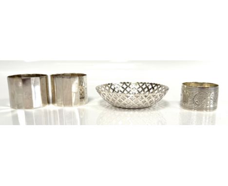 A pair of Edward VII silver napkin rings, hallmarked London 1906 Wakely &amp; Wheeler, another napkin ring and a small pierce