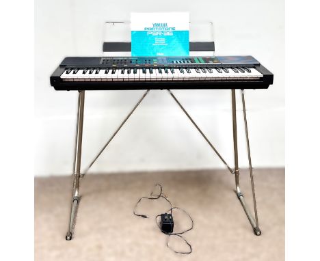 A Yamaha PSR-36 keyboard with stand.