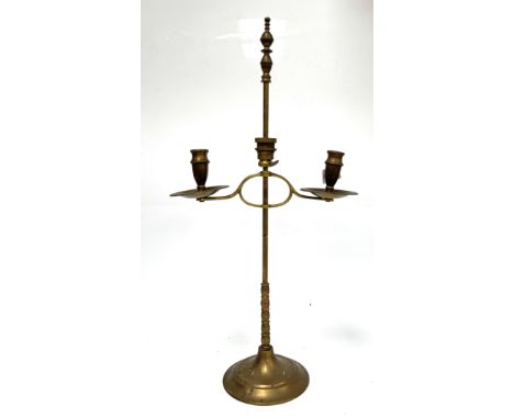 A three arm floor candelabra with flame effect, 183 x 80 cm, and a two arm brass candle stick marked Peerage to base, (2).