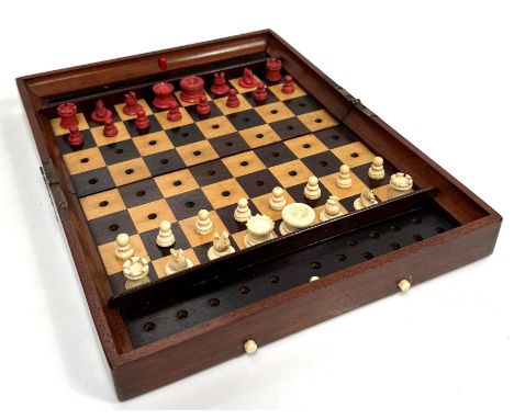 A Jaques traveling chess set with bone pieces, mahogany folding case marked "London, In Statu Quo, Chess Board", 29 x 24 cm. 