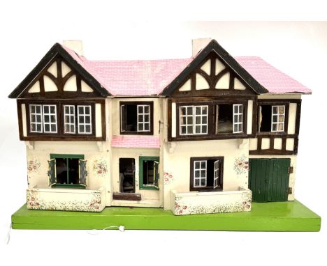 A vintage dolls house with dolls and furniture, one marked "Alwi Moeler" verso, (A lot).