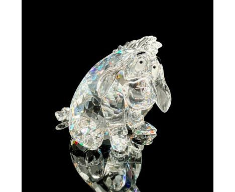 The famously gloomy character from Winnie the Pooh. This Swarovski figurine depicts Eeyore seated, featuring a faceted clear 