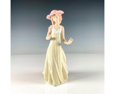 Glossy finish figure featuring a dainty young lady holding a single flower, being gently blown by a calm breeze. Model no. 11