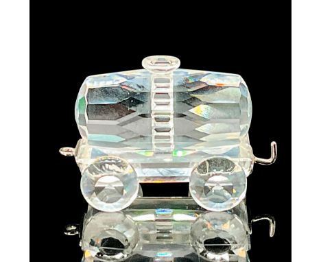 A clear crystal figure of a train tank wagon on four crystal wheels with a metal coupler. Swarovski etched backstamp. This it