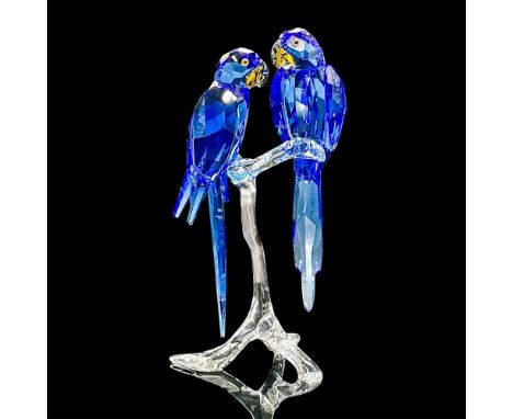 This eye-catching pair of Hyacinth Macaws symbolizes togetherness and freedom. Perched on a clear crystal branch, they sparkl