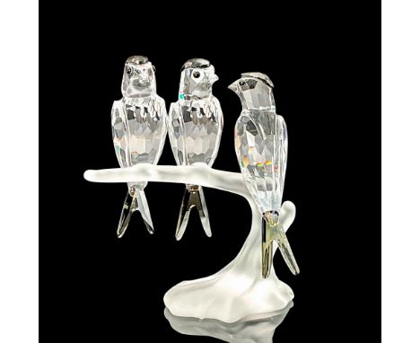 Three clear faceted crystal birds with black diamond stain crystal head and tail feathers. Perched on a frosted branch. Swaro