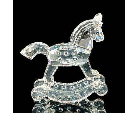 Sparkling faceted and molded crystal figurine modeled as a tiny rocking horse with blue eyes and gem-like texture details. Sw