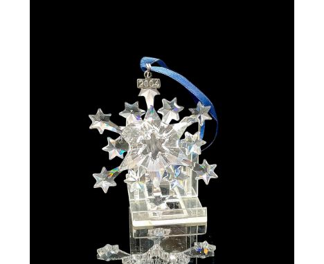 Clear crystal starburst design for the annual ornament. Blue satin ribbon included for hanging. Swarovski backstamp. 9445 200