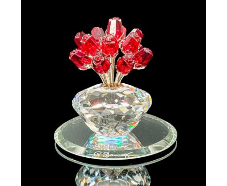 This limited-edition vase of 15 red roses symbolizes love, passion, and celebration. Made with clear crystal and rhodium stem