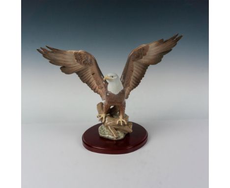 This gorgeous porcelain figurine depicts a majestic eagle standing on a branch about to take flight. This item has its origin