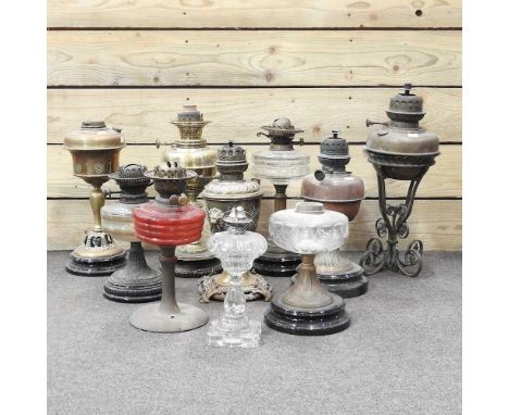 A collection of ten oil lamp bases, highest 51cm (10)
