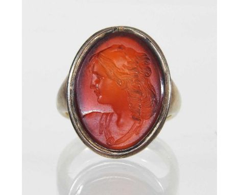 A 19th century unmarked signet ring, set with an antique chalcedony intaglio seal, carved with a head and shoulders portrait,