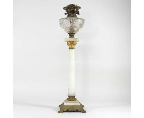 An alabaster oil lamp, with a clear glass font, 68cm high overallOverall is very dirty. The metal parts are tarnished. The gl