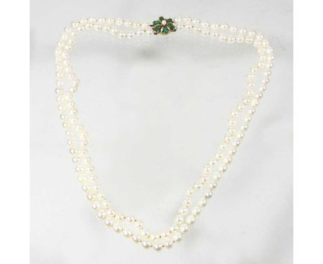 A cultured pearl double strand necklace, with a 9 carat gold and jade coloured gem set clasp, 30cm drop, 101g gross