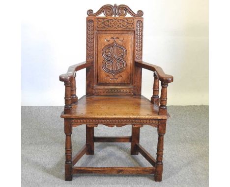 A carved oak wainscot chair64w x 4d x 102h cmOverall it is solid, usable and well-made, mid to late 20th century in date, in 