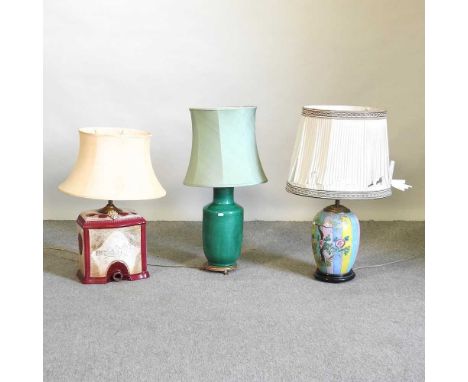 A Chinese famille verte pottery lamp base, on a brass stand, with shade, 75cm high, together with two others (3)We are not ab