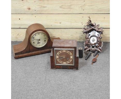 An early 20th century Black Forest style cuckoo clock, 35cm high, together with two various mantel clocks (3)