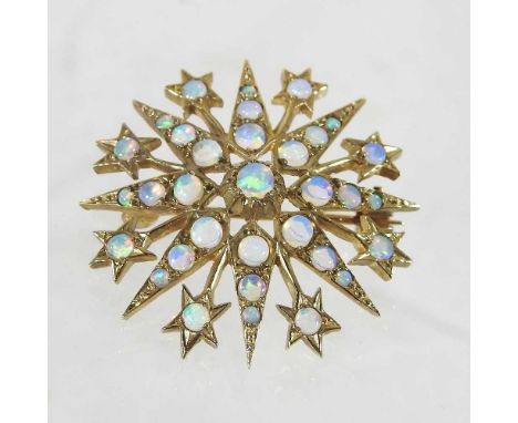 A 9 carat gold opal brooch, of star shape, set throughout with graduated stones, 5.3g gross, 3cm diameter, boxedOverall condi