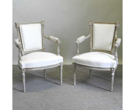 A pair of continental cream upholstered and painted armchairs, 20th century, on turned legs (2)Both are solid and usable. The