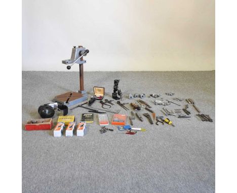 A collection of hand tools, together with a drill press