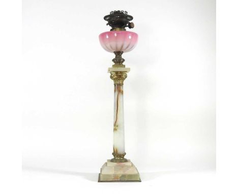 An onyx oil lamp base, with a pink glass font, 64cm high overallOverall condition is complete but dirty. There are fine chips