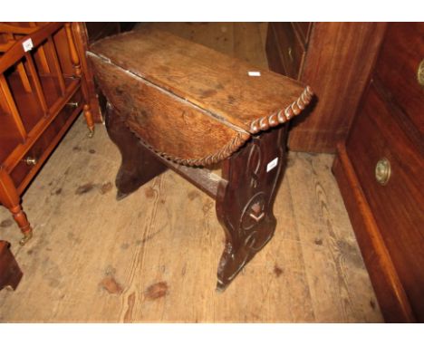 Small early 20th Century oak drop-leaf occasional table with pie crust rim, together with an early 20th Century carved aneroi