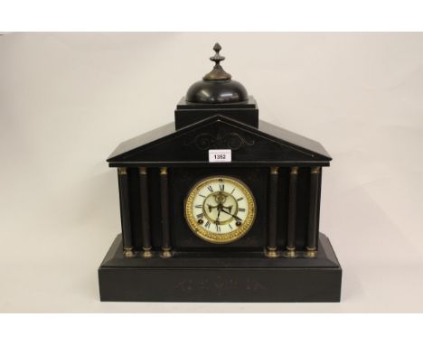 Late 19th Century black slate mantel clock, the architectural case with enamel dial, Roman numerals and visible escapement wi