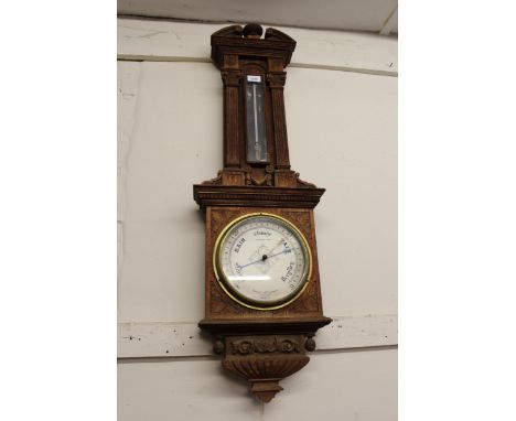 Late 19th / early 20th Century carved oak aneroid barometer thermometer by Negretti & Zambra, in architectural form case (the