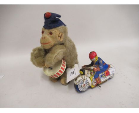 Mid 20th Century clockwork toy in the form of a monkey playing a drum, together with a small tinplate toy in the form of a po